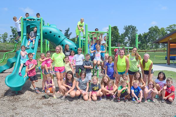 Children and counselors on playground at Summer Playground Camp
