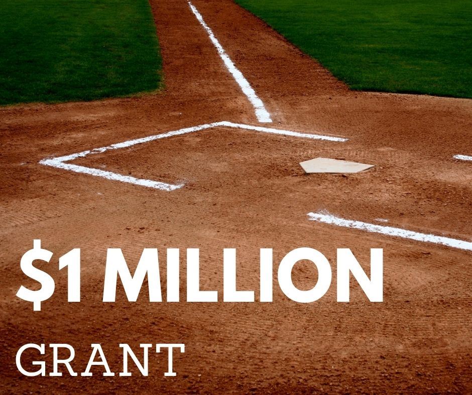 1 million grant with photo of home plate area on field