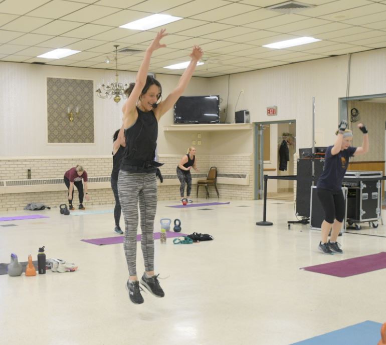 Katie Logan jumping during fitness class