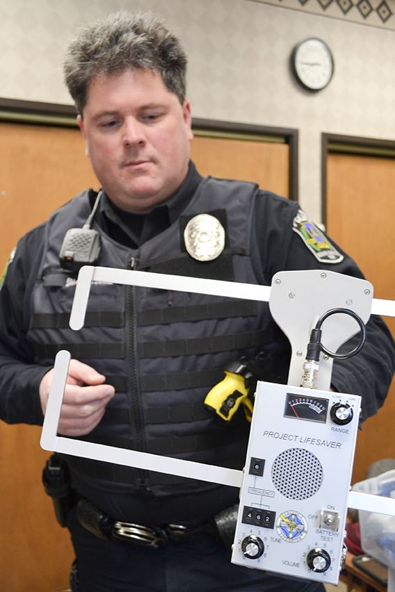 Officer holding transmitter with Project Lifesaver text